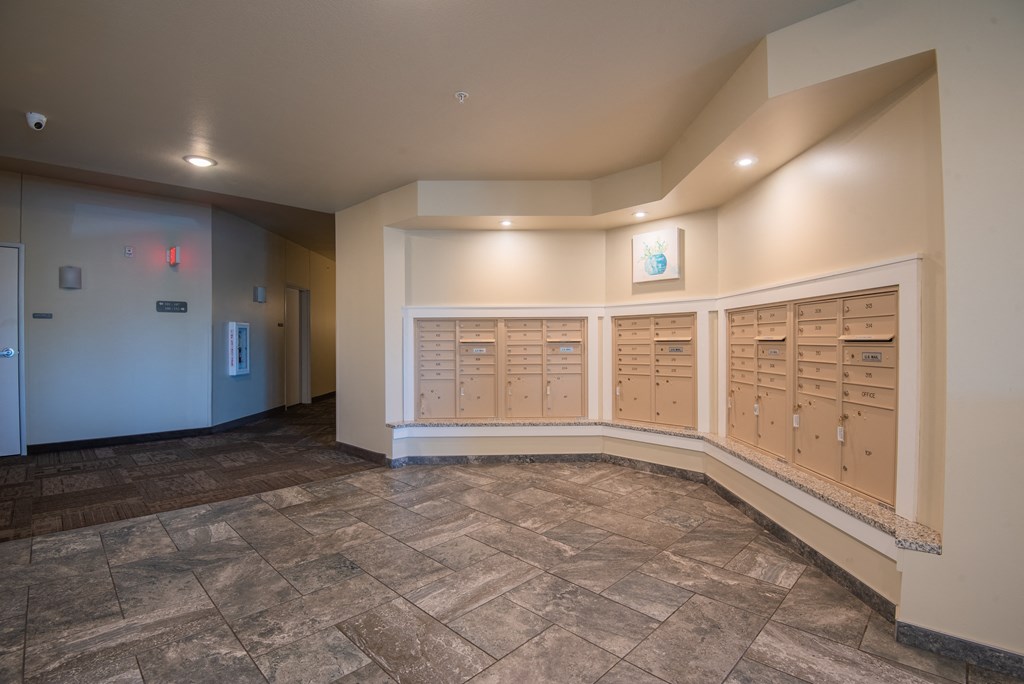 A hallway with a row of lockers on the right side.