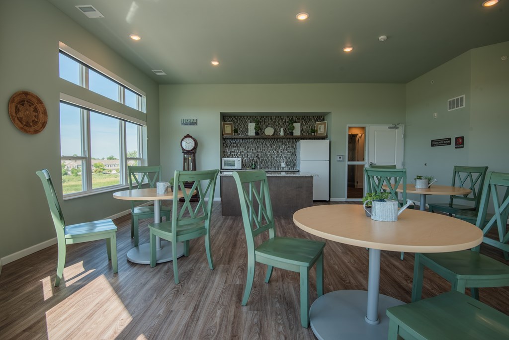 A dining room with a round table and chairs.