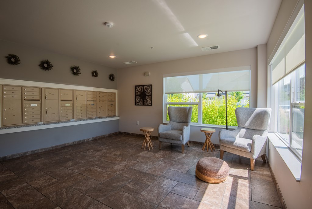 A room with a table, chairs and a window.