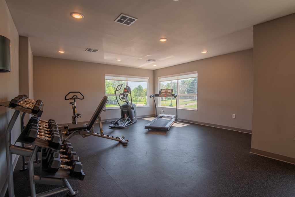 A spacious home gym with a variety of equipment.