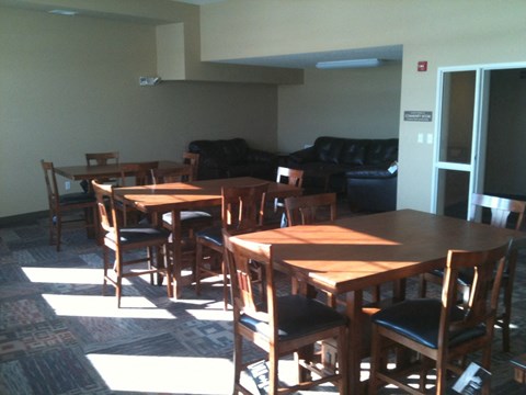 a dining room with wooden tables and chairs