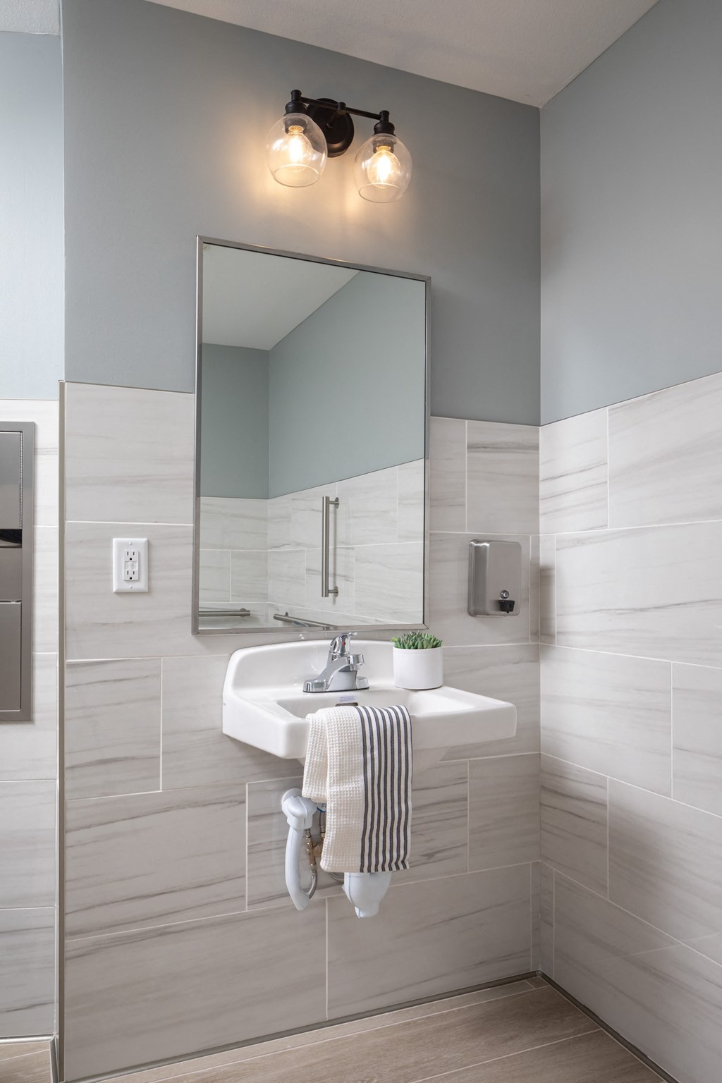 a white bathroom with a sink and a mirror