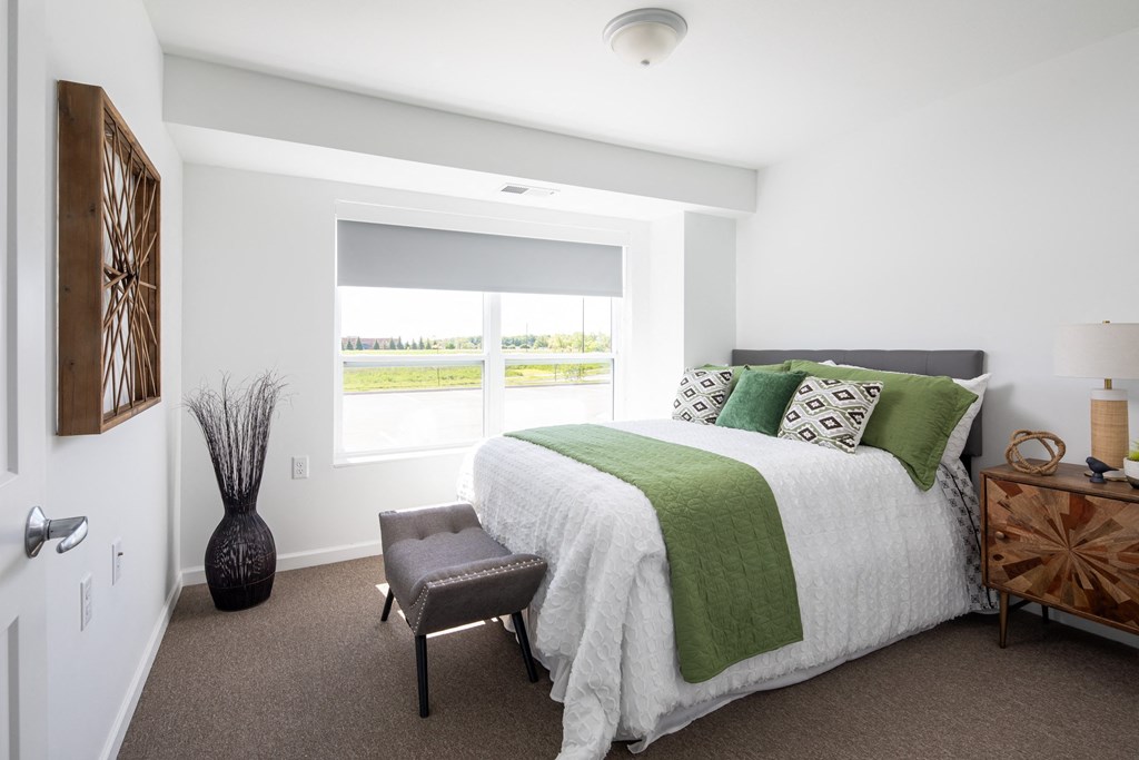 a bedroom with a bed and a window