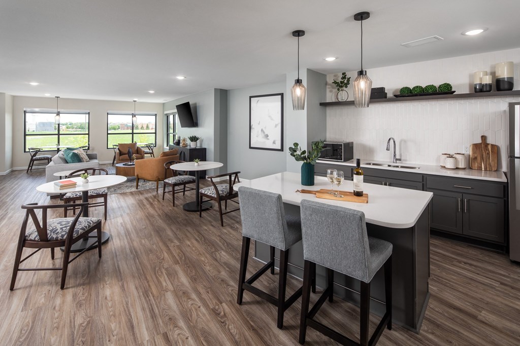 an open kitchen and living room with a table and chairs