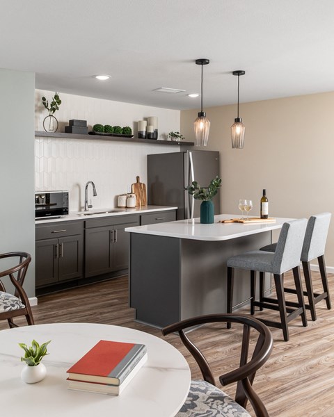 an open kitchen and dining area with a table and chairs