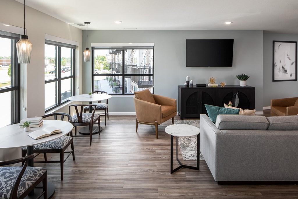 a living room with a couch and tables and a television