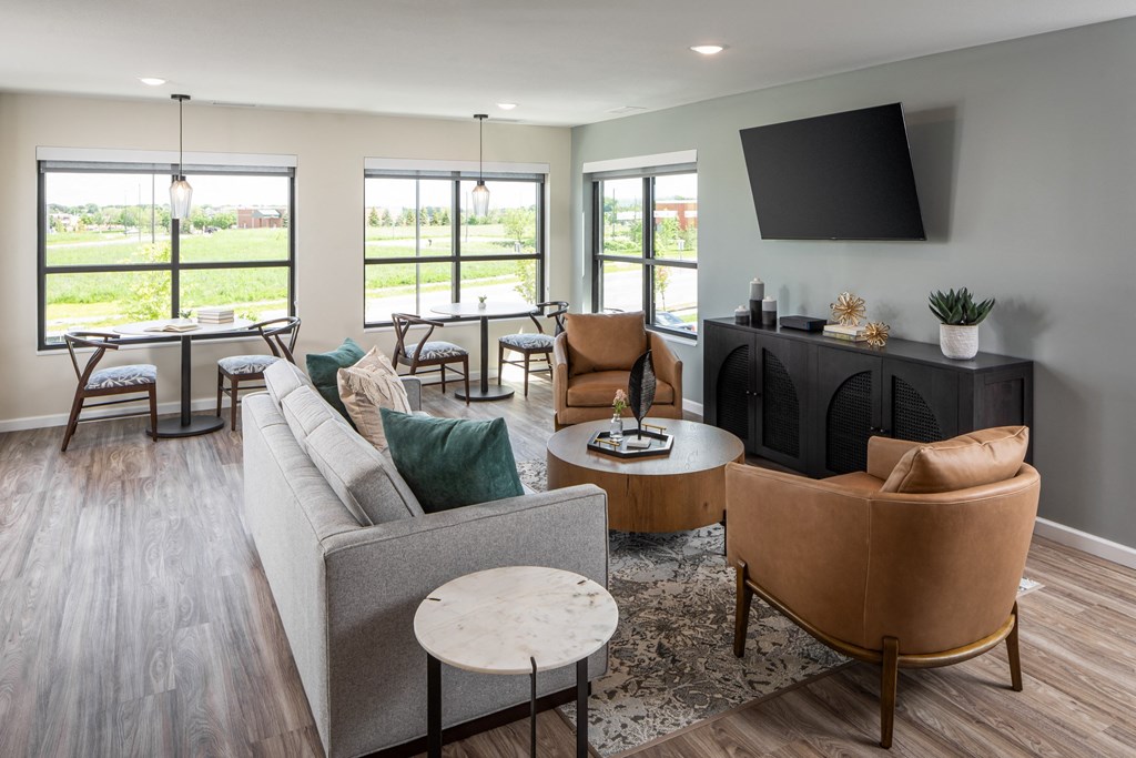 a living room with couches and chairs and a tv