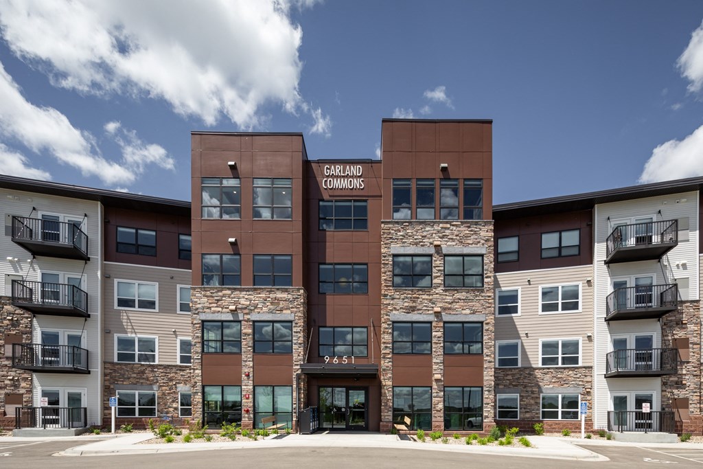 an exterior view of an apartment building with stone and brown exterior walls