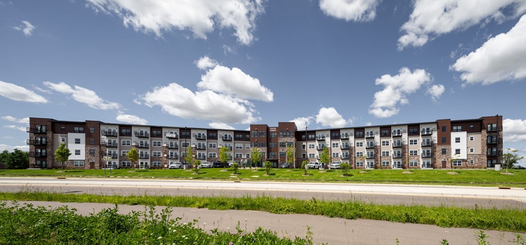 an exterior view of an apartment building on a sunny day