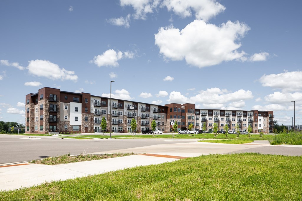 a large apartment building on the side of a road