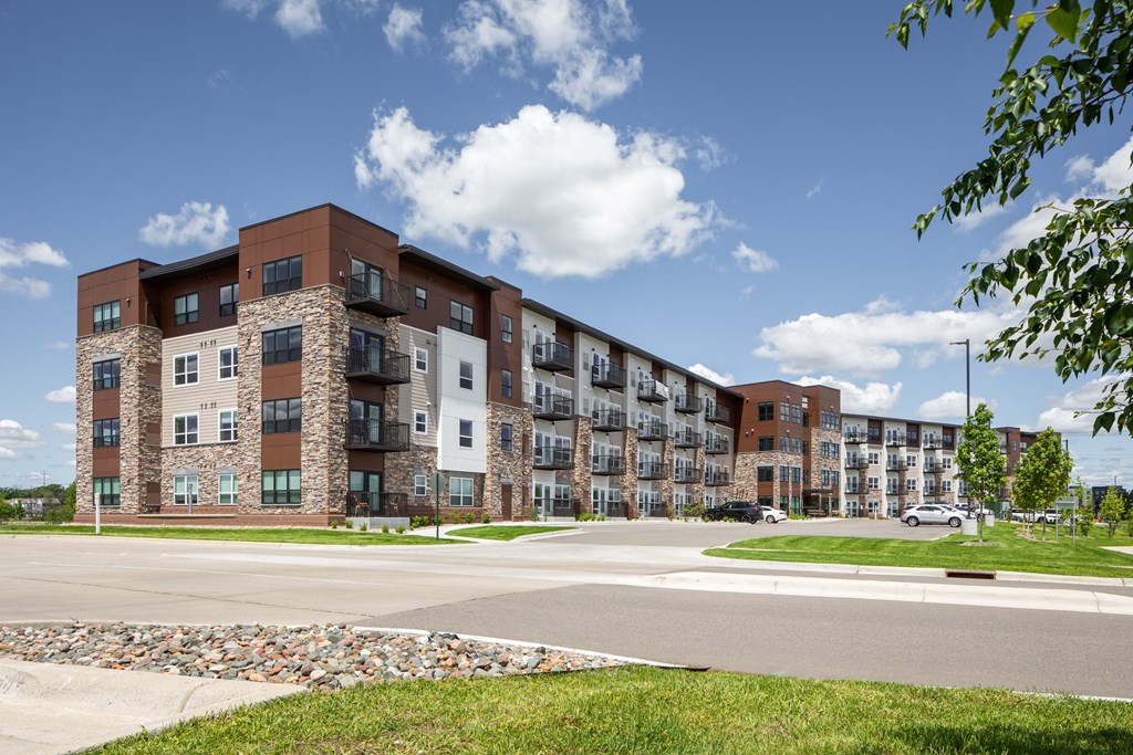 a large apartment building on the corner of a street