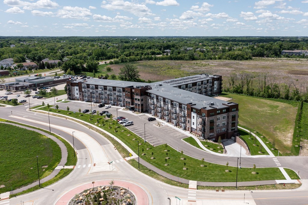 an aerial view of an apartment building next to a road