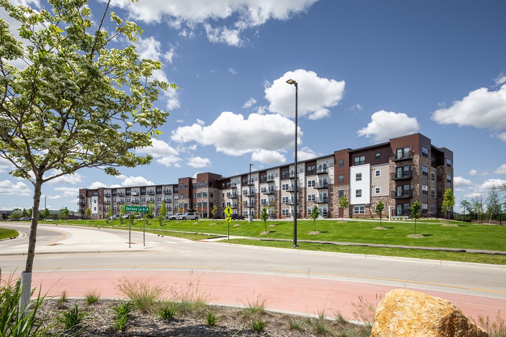 an empty street with an apartment building in the background
