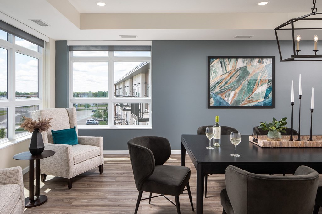 a dining room with a table and chairs and a large window
