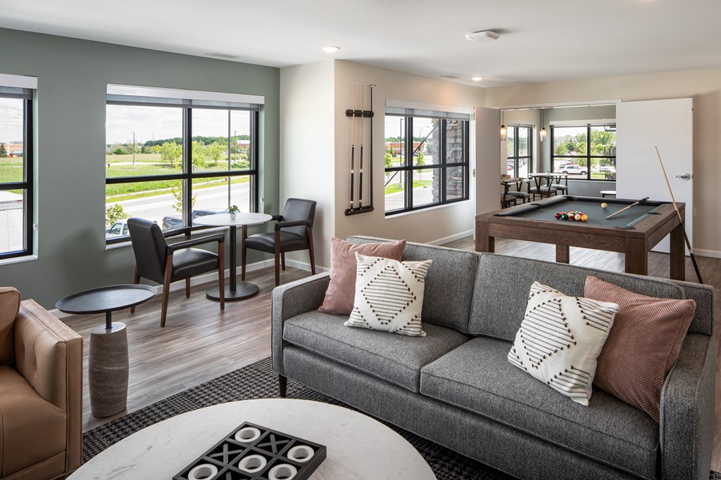 a living room with a couch and a pool table