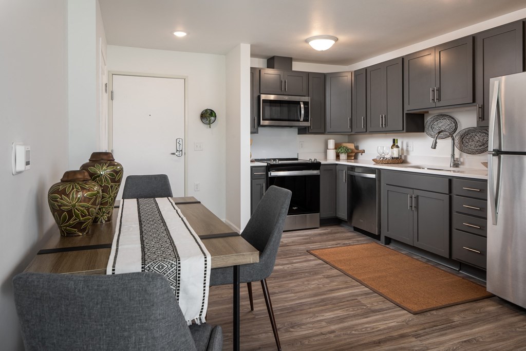 a kitchen and dining room with a table and chairs