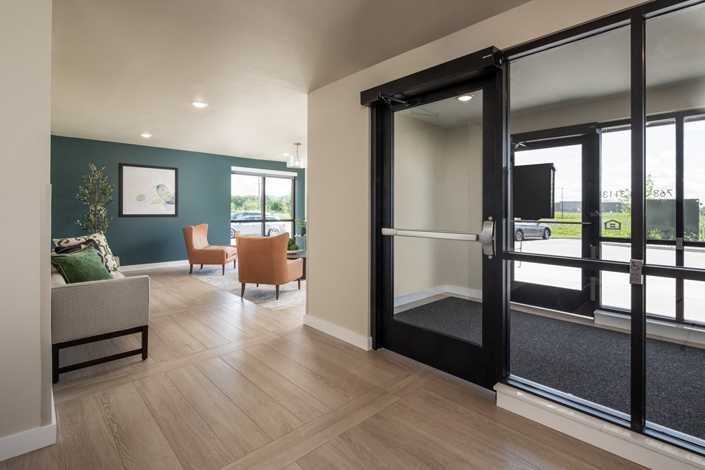 a living room with sliding glass doors and a table with chairs