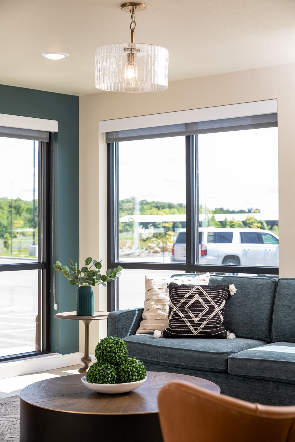 a living room with a couch and a table and windows