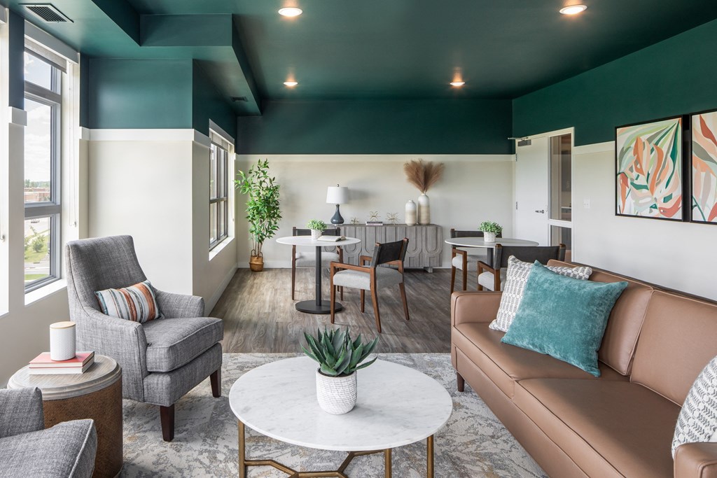 a living room with couches and chairs and a table