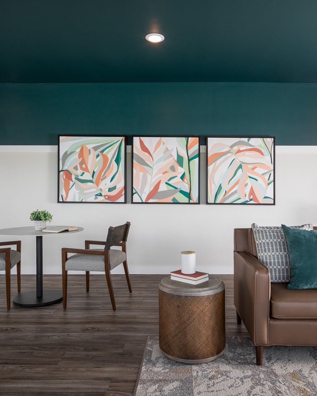 a living room with a couch and chairs and a table