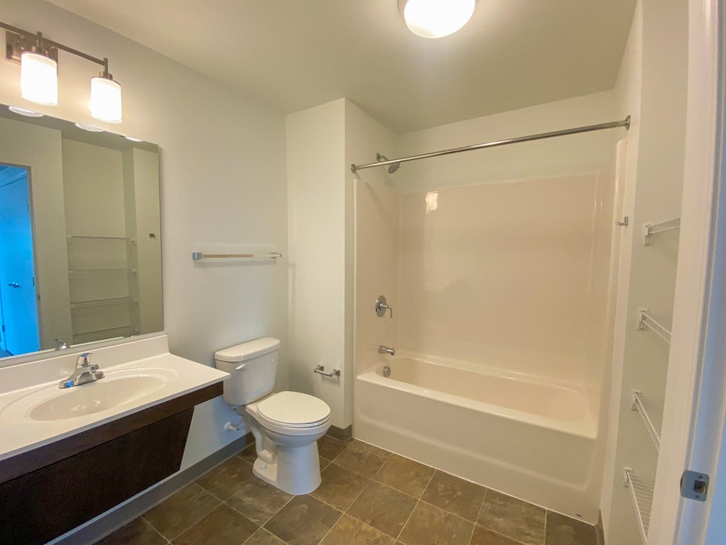 A white toilet sits next to a sink in a bathroom.