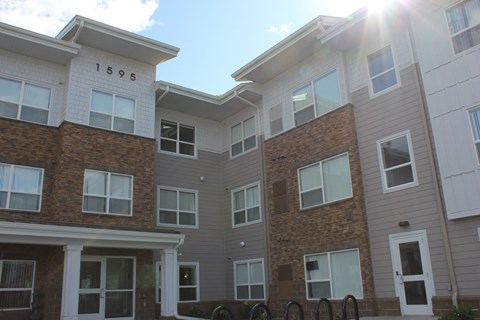 The sun is shining on the front of apartment building 1595.