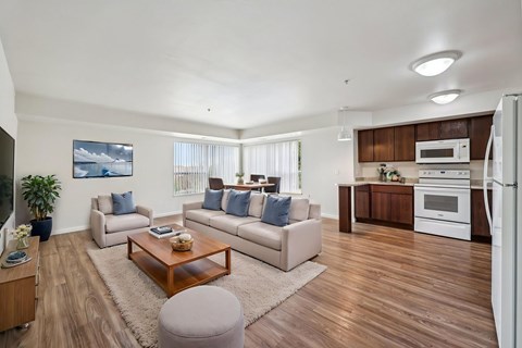 A modern living room with a white couch and a wooden coffee table.