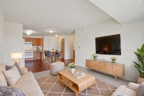 A living room with a couch, coffee table, and television.