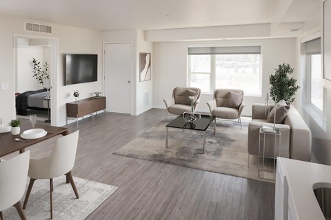 A modern living room with a wooden floor and furniture.