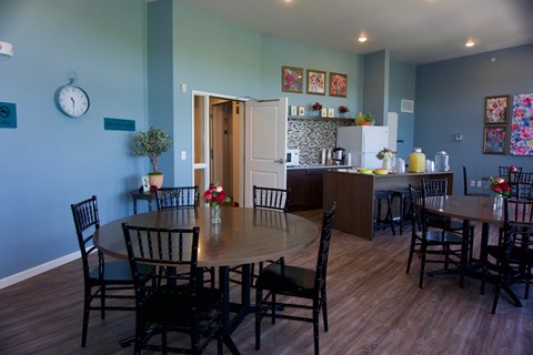 A dining room with a table set for six.