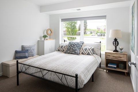 a bedroom with a bed and a window