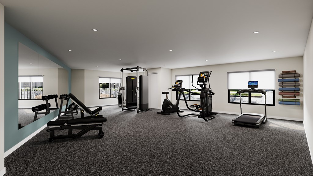 A spacious gym with a variety of equipment including a treadmill, weights, and a bench press.