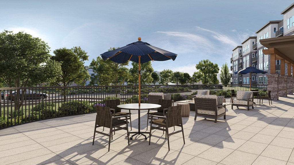 a patio with tables and chairs and an umbrella