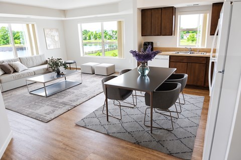 A modern dining room with a glass table and chairs.