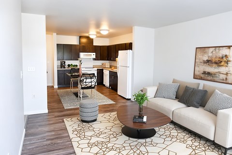 A modern living room with a white couch and a coffee table.