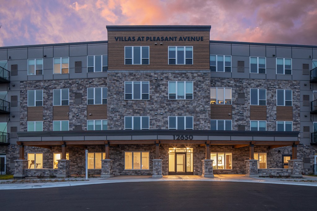 an exterior view of the villas at phoenix arriving at dusk