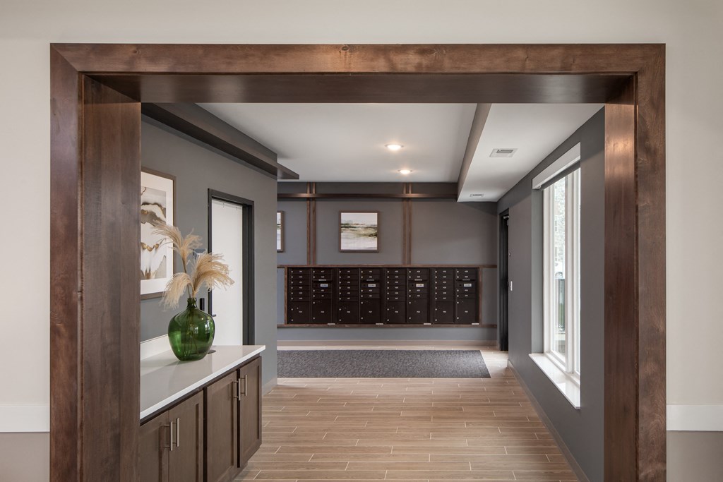 a hallway with a door way to a room with a wine cellar and a window