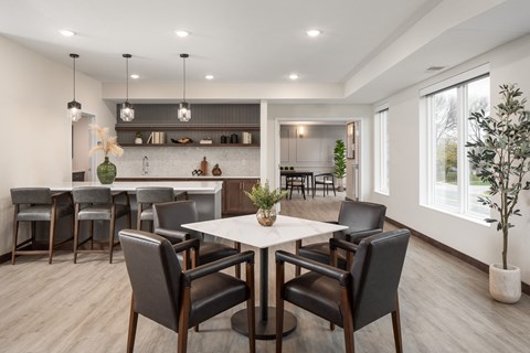 a dining room and kitchen with a table and chairs