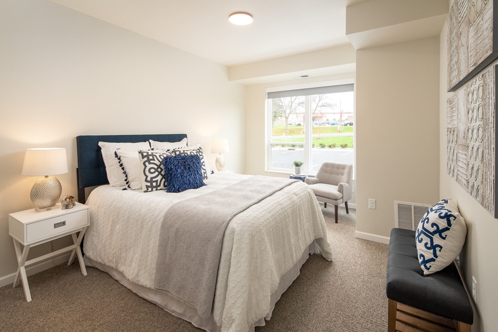 a bedroom with a large bed and a window