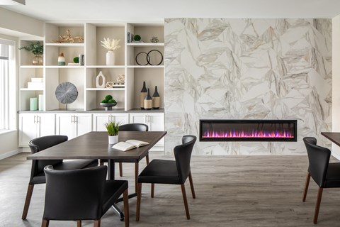 A modern dining room with a table set for four.