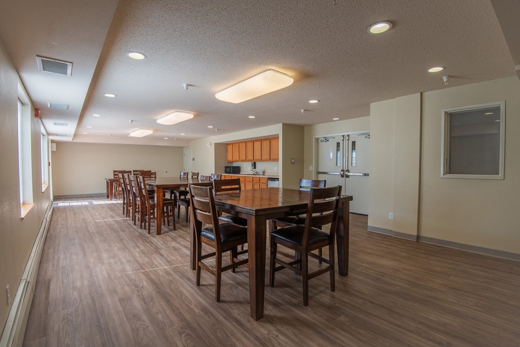 a large dining room with a large table and chairs