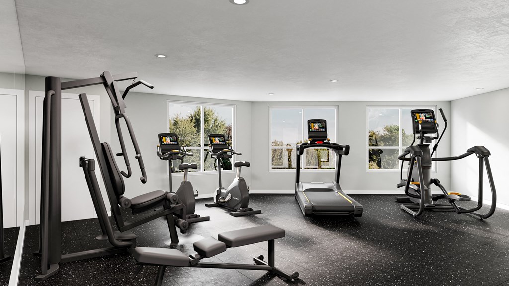 a gym with treadmills and other exercise equipment in a room with windows