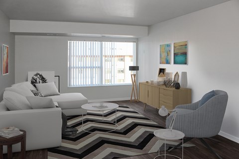 A living room with a white couch, a grey armchair, and a wooden cabinet.