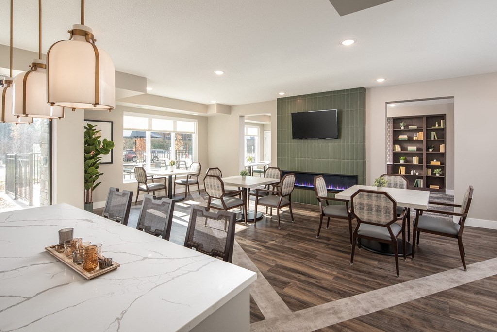 A modern dining room with a long table and chairs.