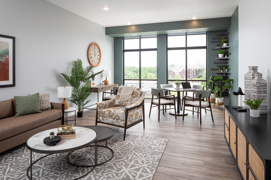 a living room with a couch and a table in front of a window