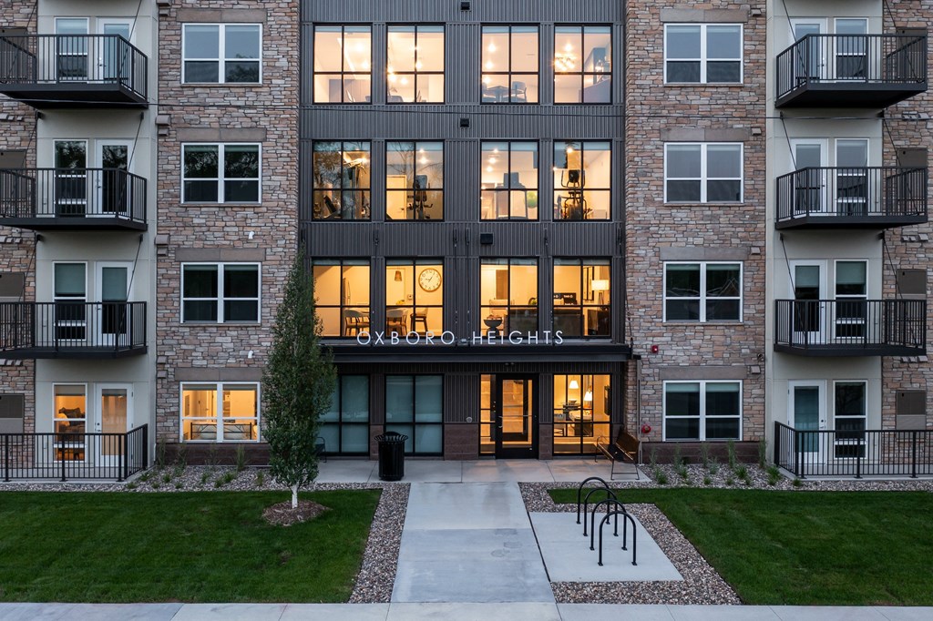 view of the front entrance of an apartment building at night
