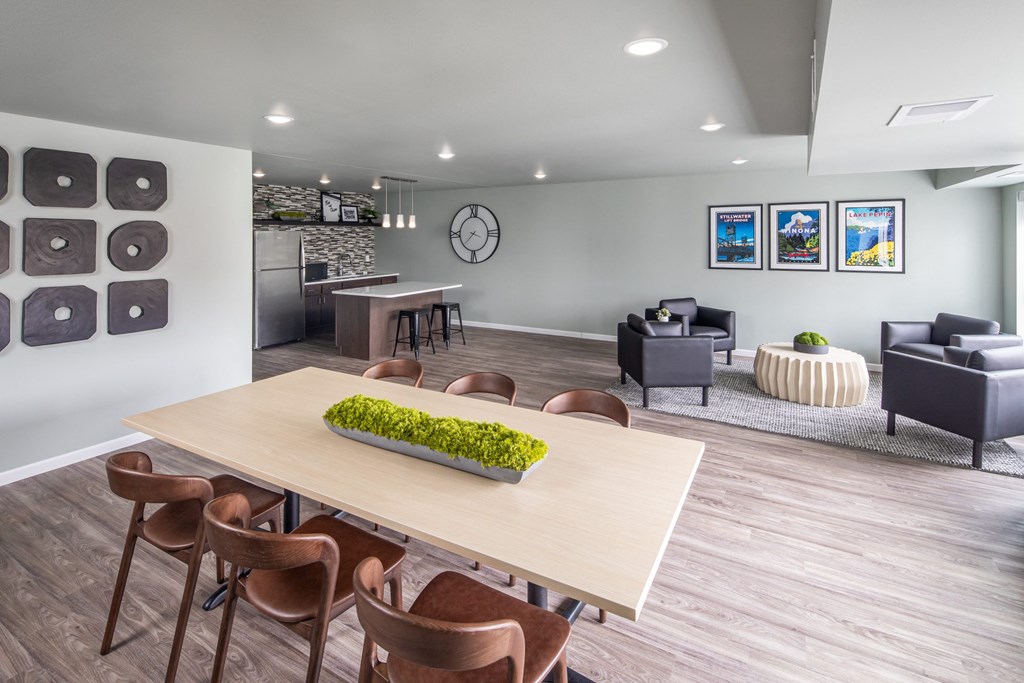 A modern dining room with a long table and chairs.