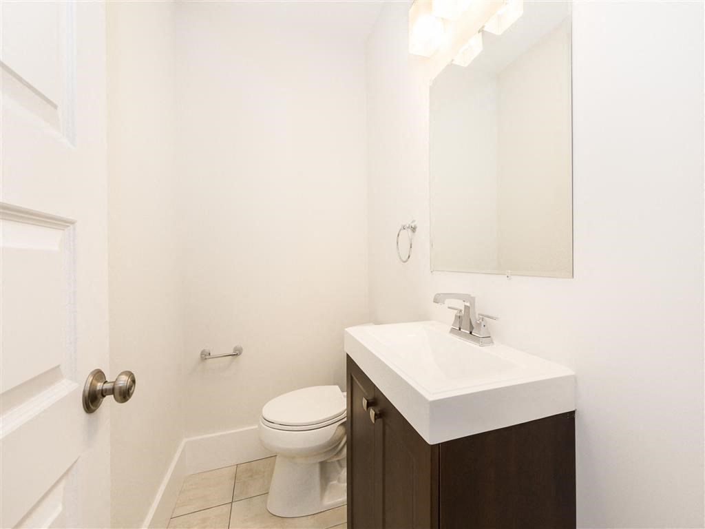 a bathroom with a sink toilet and a mirror