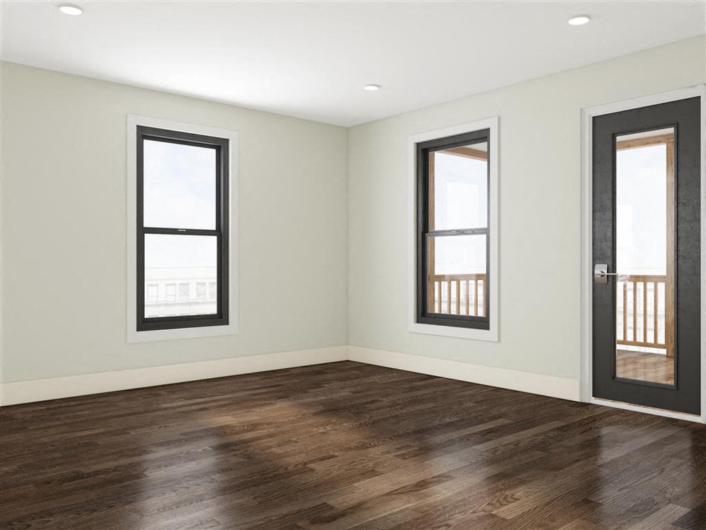 an empty living room with wood floors and windows