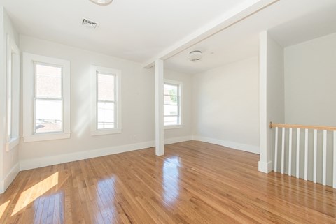 A room with wooden floors and white walls.